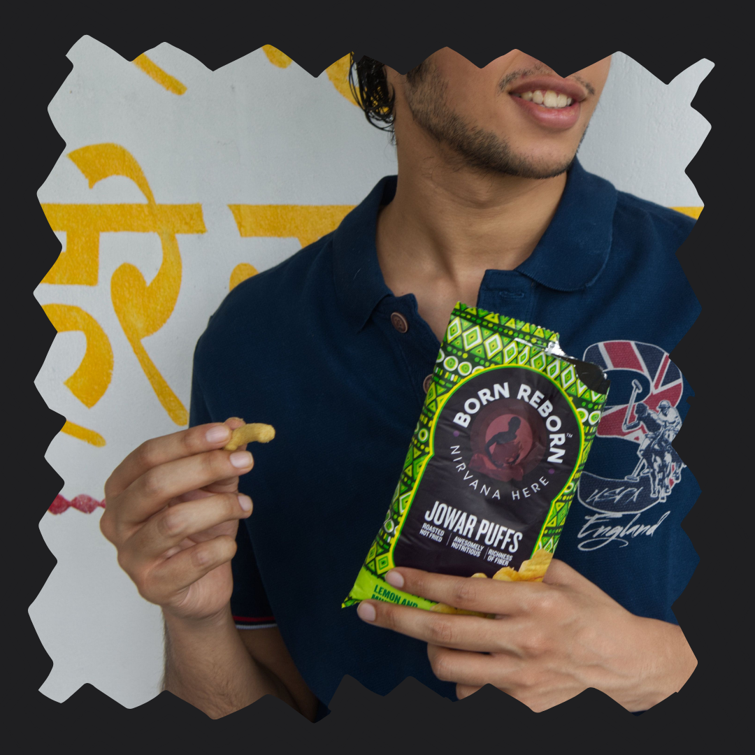 A man is enjoying Born reborn jowar puffs with lemon and mint bliss which is he healthy and enjoyable evening snacking